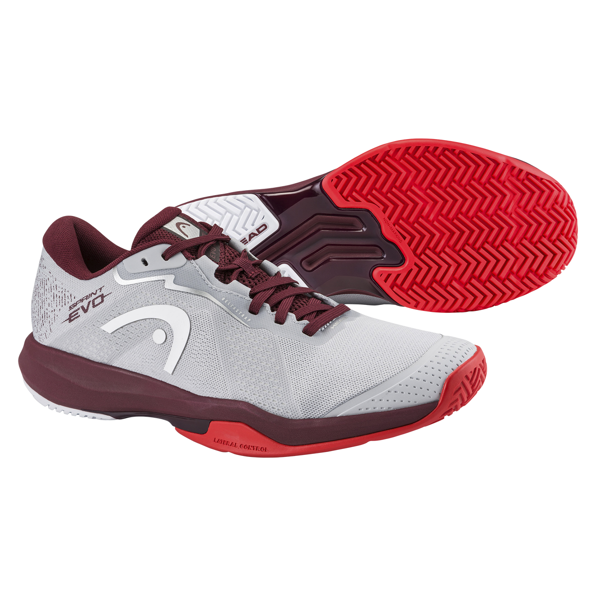 Product image of a HEAD Sprint Evo men’s tennis shoe on a black background, showing one shoe in side profile with a light grey mesh upper, burgundy collar and laces, white HEAD logo, and supportive midsole, alongside a second shoe angled to display the red non-marking herringbone outsole designed for court traction.