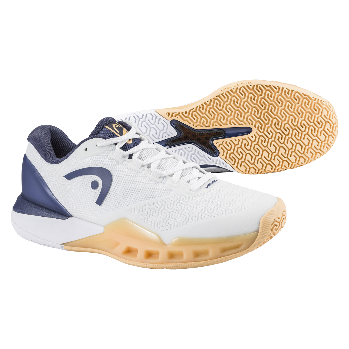 Studio product image of a HEAD Revolt Pro 5.0 women’s tennis shoe in white and navy with a gum outsole, shown with a second shoe displaying the patterned sole for traction and lateral support.