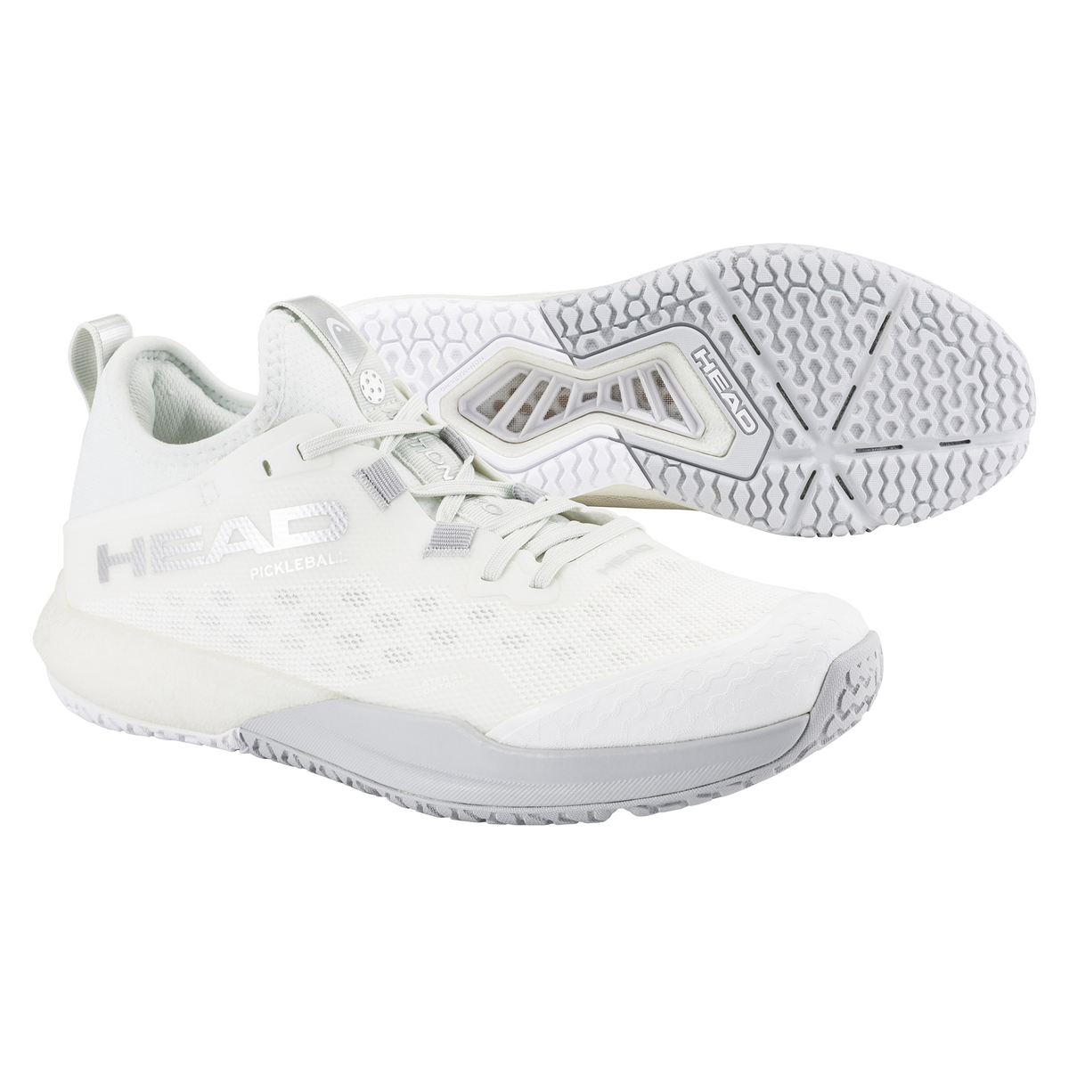 HEAD Motion Pro women’s pickleball shoe in white, shown in a studio product view with one shoe angled forward and the other displaying the outsole, highlighting the breathable mesh upper, reinforced lateral support, cushioned midsole, and non-marking pickleball-specific tread.