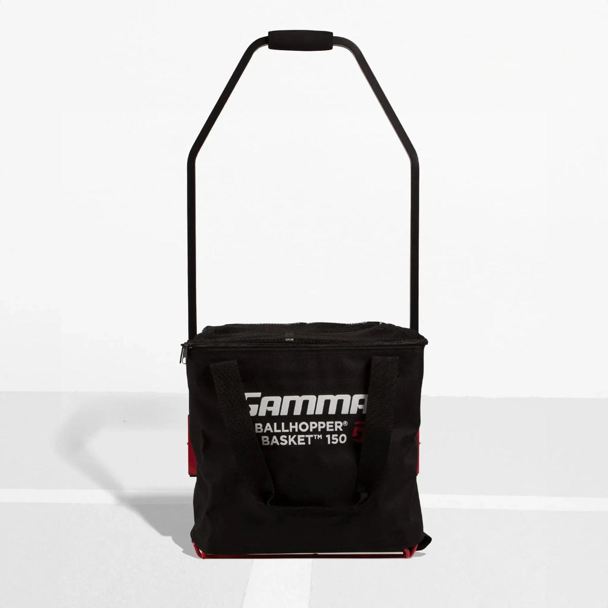 Portable ball hopper basket with fabric storage compartment, carry handles, and a standing frame for easy transport and access during practice.