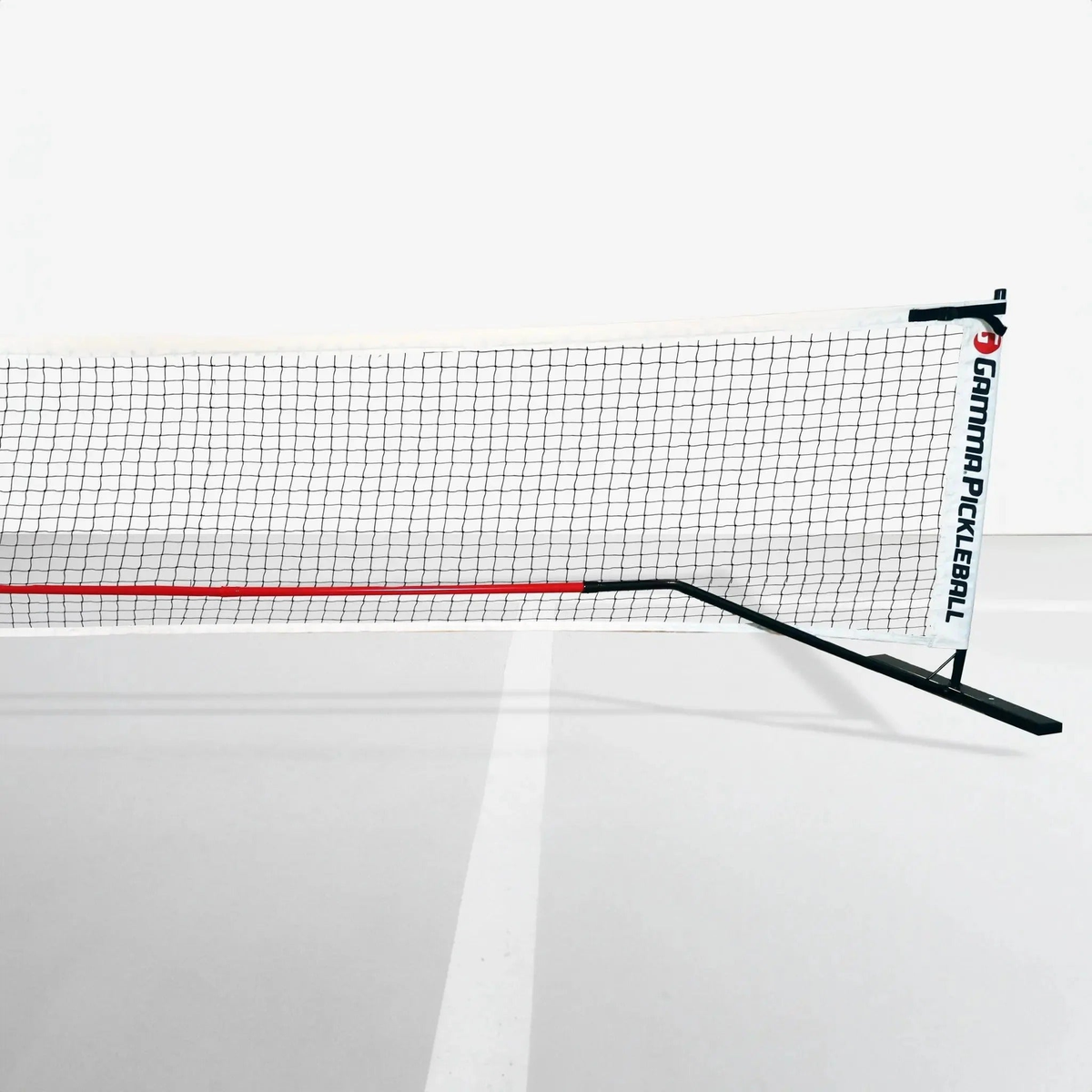 Portable pickleball net system with mesh netting and a stable frame designed for easy setup on a court.
