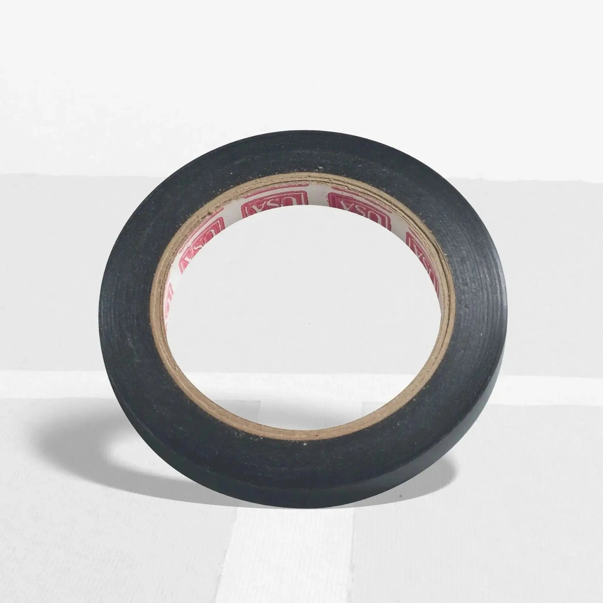 Roll of grip finishing tape used to secure overgrips on racquet handles for a clean and secure finish.