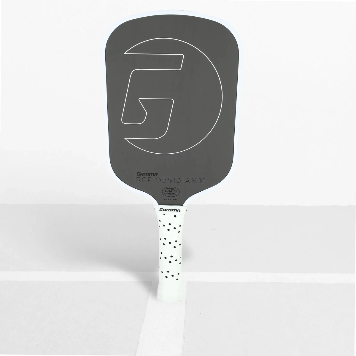 Pickleball paddle with a textured face, wide body shape, and cushioned grip handle designed for control and performance.