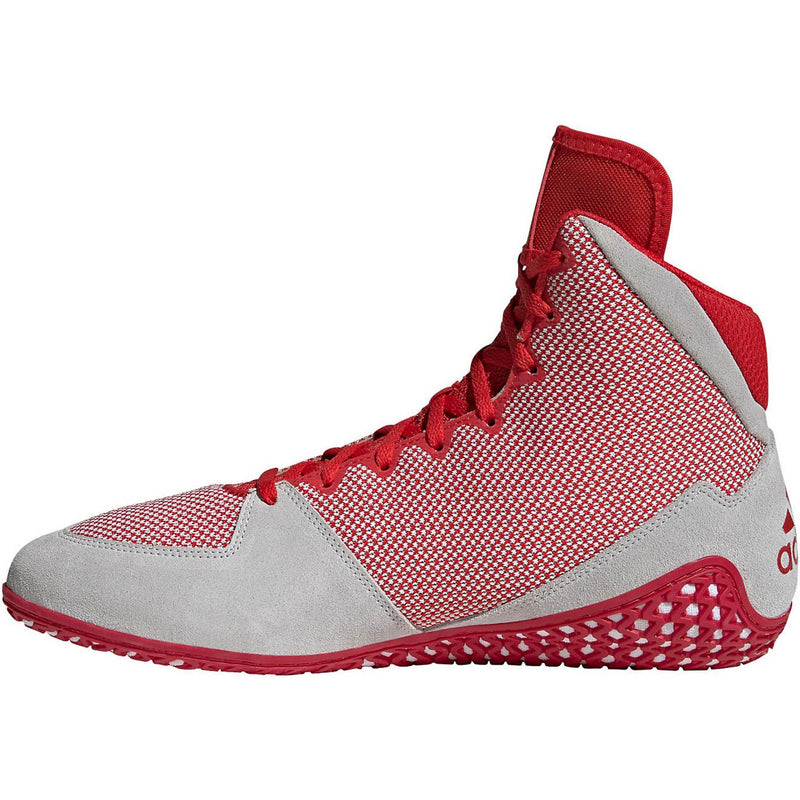 Red high-top wrestling shoes with a breathable knit upper, white three-stripe side branding, and light gray suede-style toe and heel overlays; shown in side and sole views, featuring a red rubber outsole with a dense honeycomb traction pattern and Adidas logo for grip and mat control.