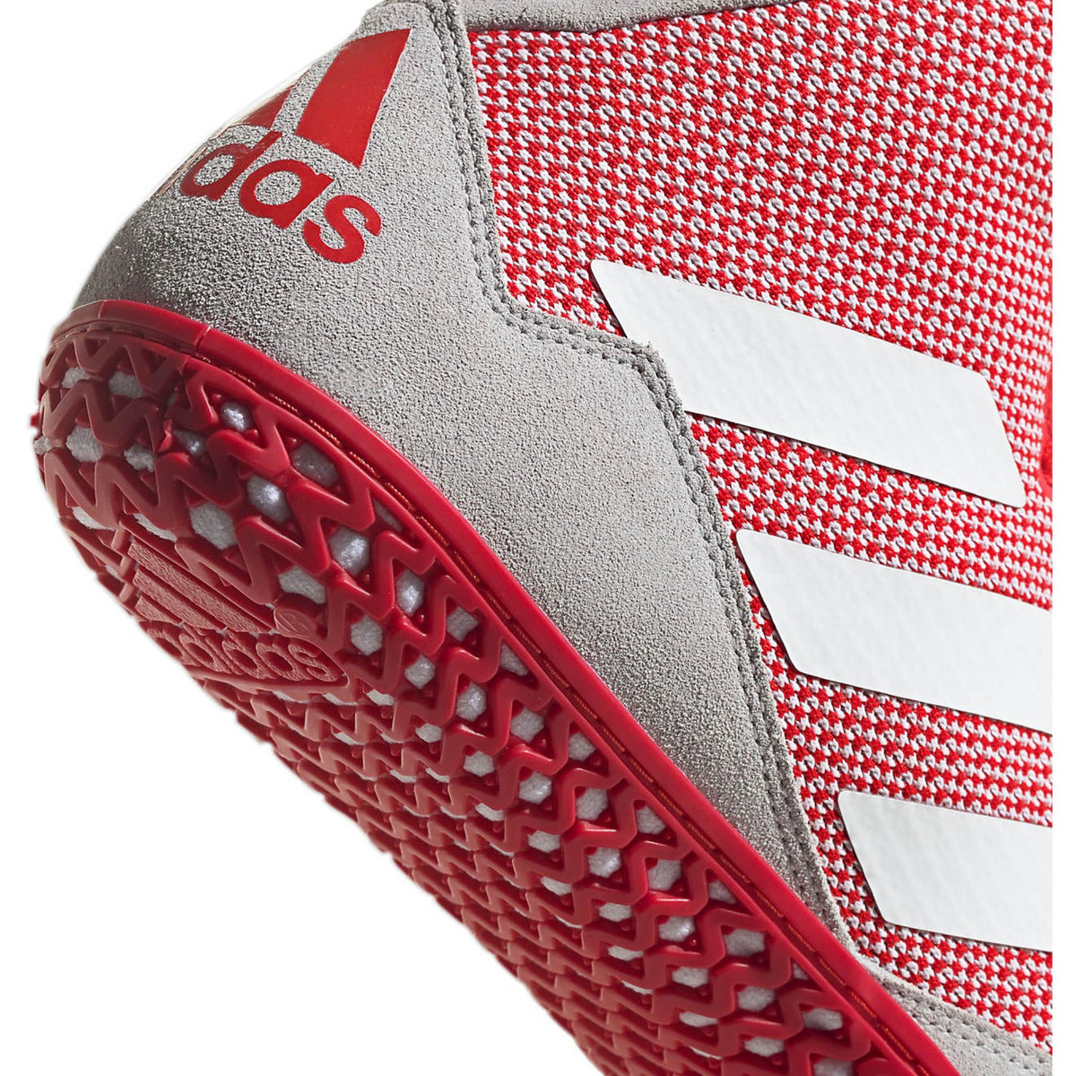 Red high-top wrestling shoes with a breathable knit upper, white three-stripe side branding, and light gray suede-style toe and heel overlays; shown in side and sole views, featuring a red rubber outsole with a dense honeycomb traction pattern and Adidas logo for grip and mat control.