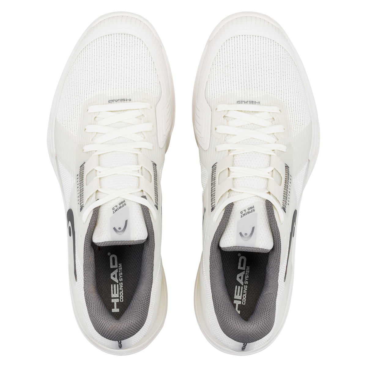 A studio product image of the HEAD Sprint Pro 4.0 men’s tennis shoe in a clean white and light gray colorway on a black background. One shoe is shown in a side profile, emphasizing the lightweight breathable mesh upper, DeltaStrap support system, reinforced toe guard, and sculpted midsole for lateral stability. The second shoe is positioned behind it to showcase the white non-marking outsole with a textured herringbone-style tread pattern and a visible midfoot support shank featuring subtle HEAD branding.
