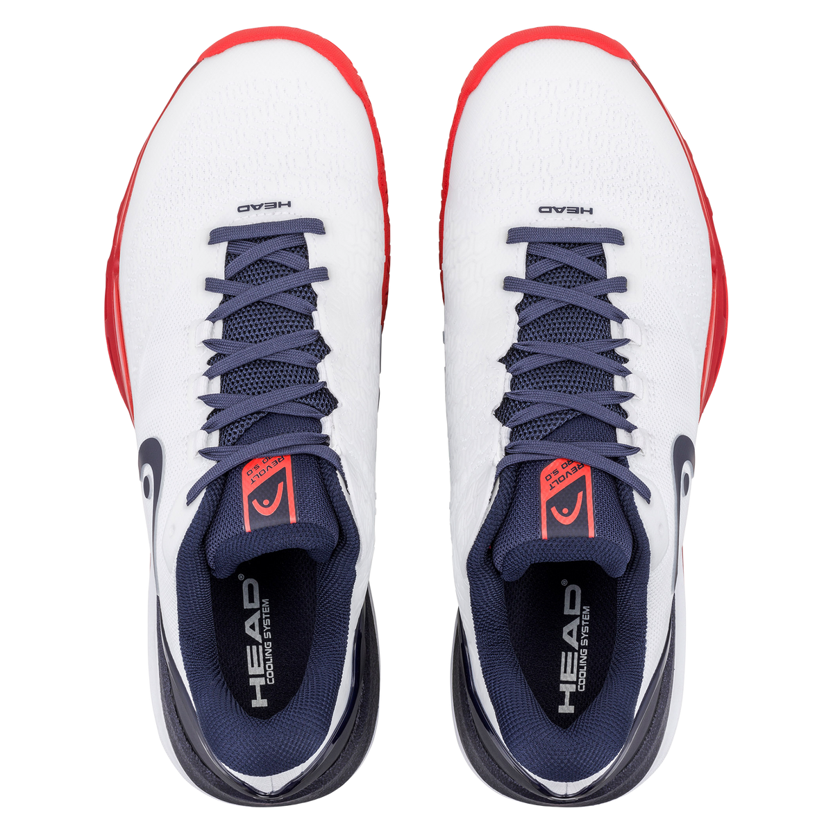 Product image of a white and navy HEAD Revolt Pro men’s tennis shoe on a black background, featuring one shoe in side profile with a breathable mesh upper, dark laces, HEAD logo, and red-accented cushioned midsole, alongside a second shoe flipped to show the red non-marking outsole with geometric traction pattern and lateral stability support.