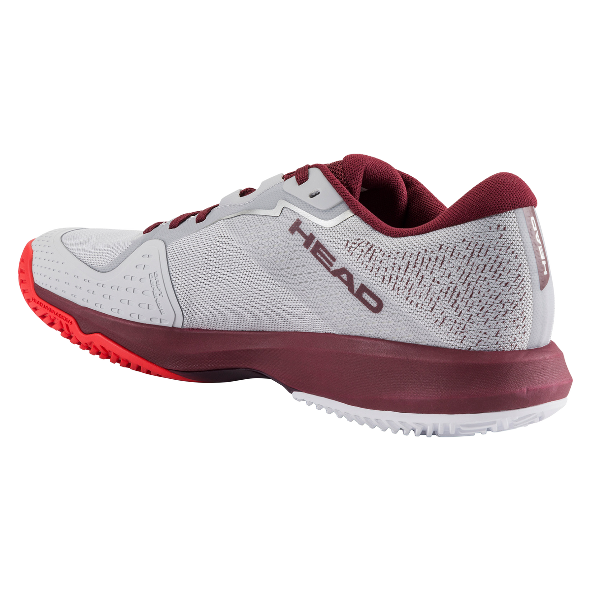 Product image of a HEAD Sprint Evo men’s tennis shoe on a black background, showing one shoe in side profile with a light grey mesh upper, burgundy collar and laces, white HEAD logo, and supportive midsole, alongside a second shoe angled to display the red non-marking herringbone outsole designed for court traction.