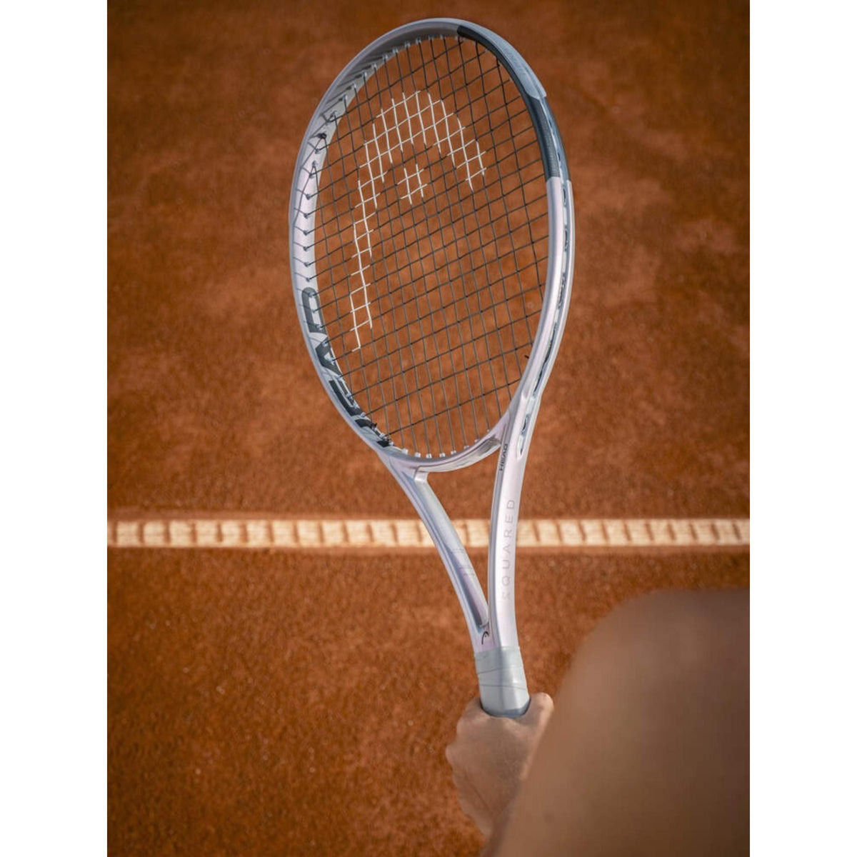 Tennis racquet with a squared head shape, strung face, and ergonomic handle designed for performance and control.