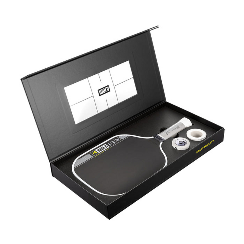 Table tennis paddle set with accessories in a black box on a white background