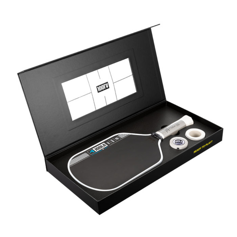 Pickleball paddle and ball set in a black box with a visible brand logo.