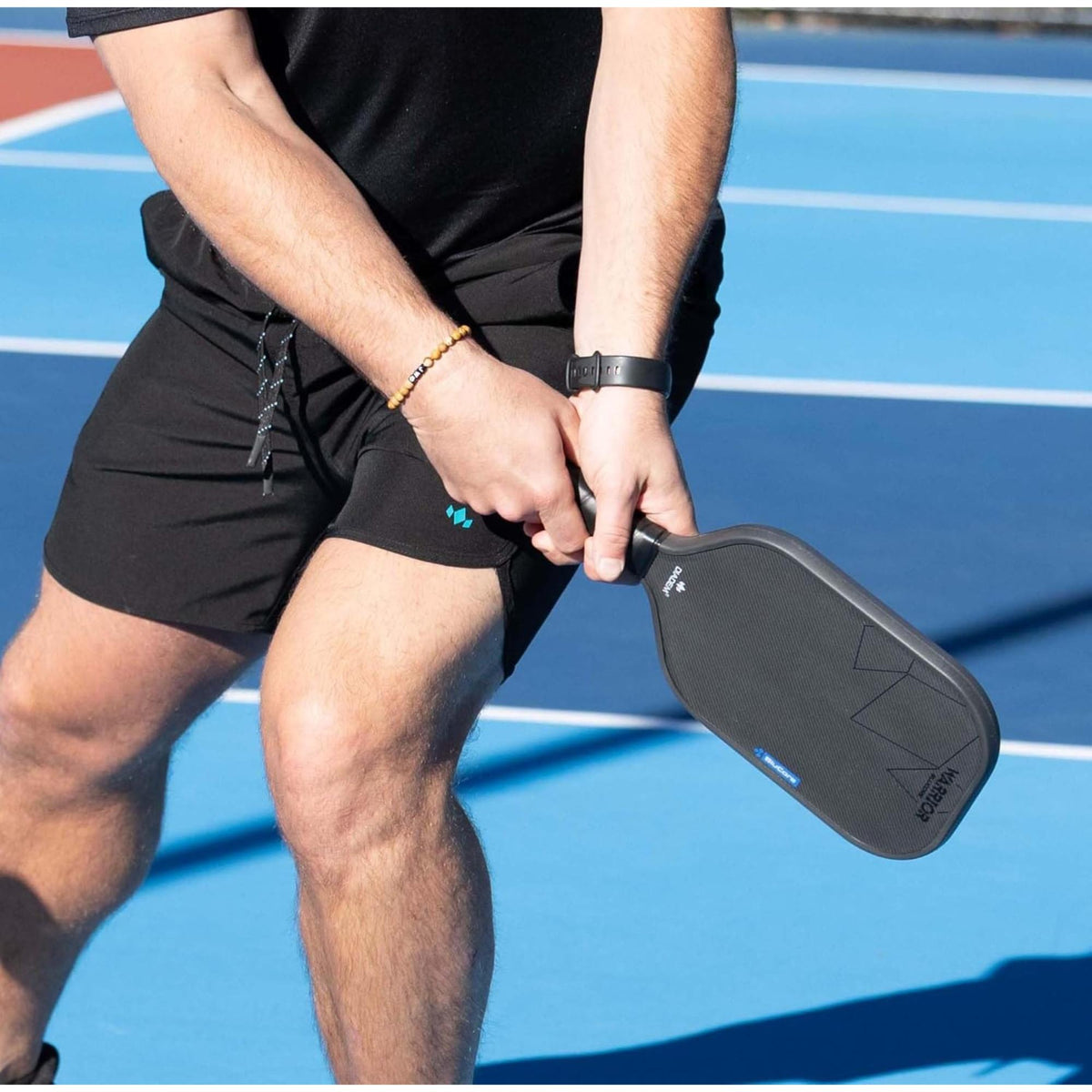 Pickleball paddle with a textured face surface, geometric design accents, and a cushioned grip handle.