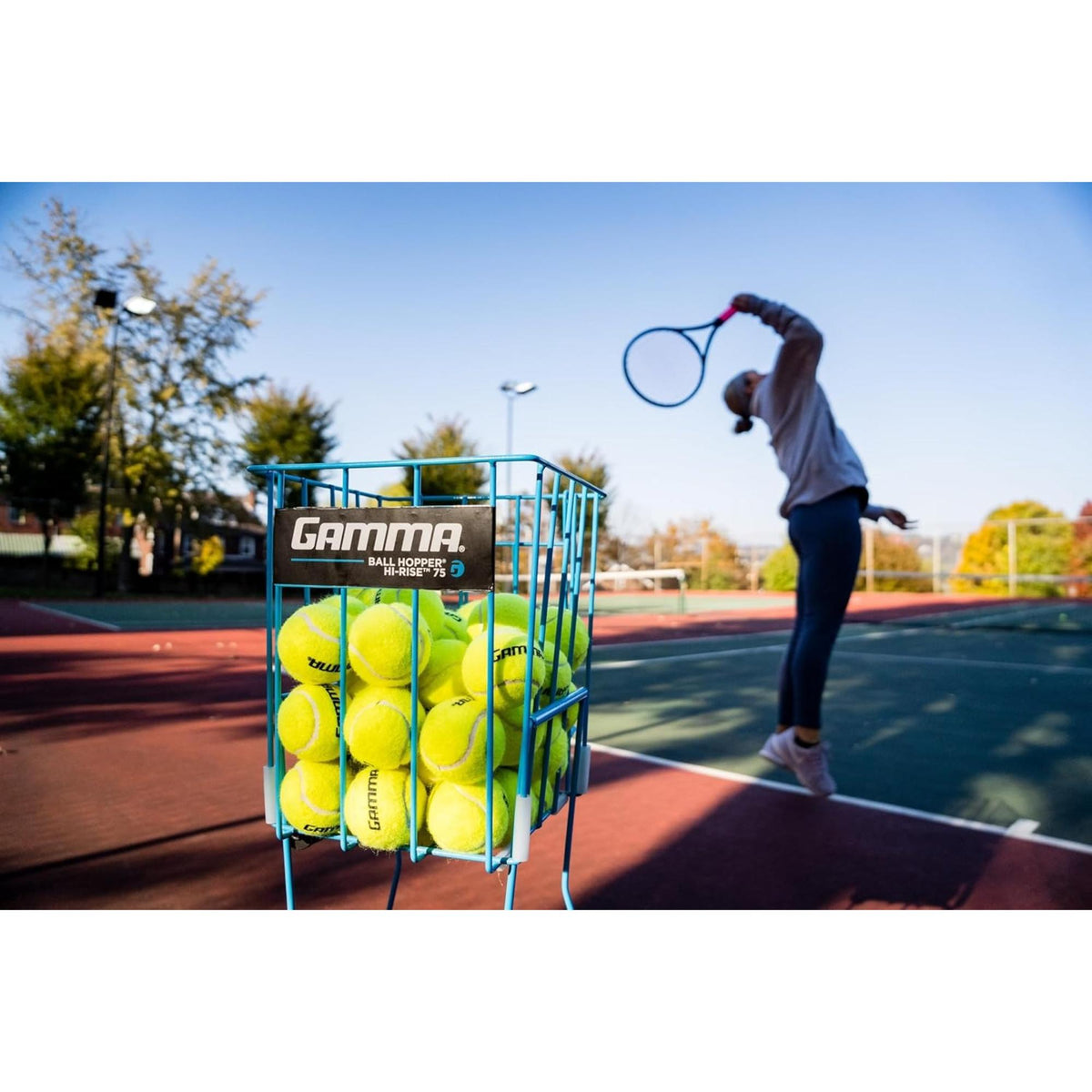 Portable tennis ball hopper basket with stand, designed for easy storage, transport, and convenient access to multiple tennis balls during practice.