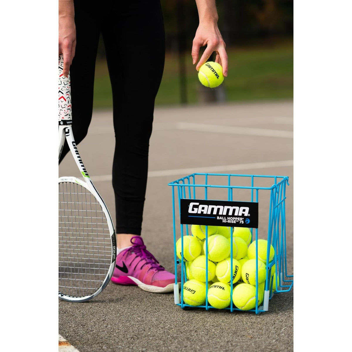Portable tennis ball hopper basket with stand, designed for easy storage, transport, and convenient access to multiple tennis balls during practice.