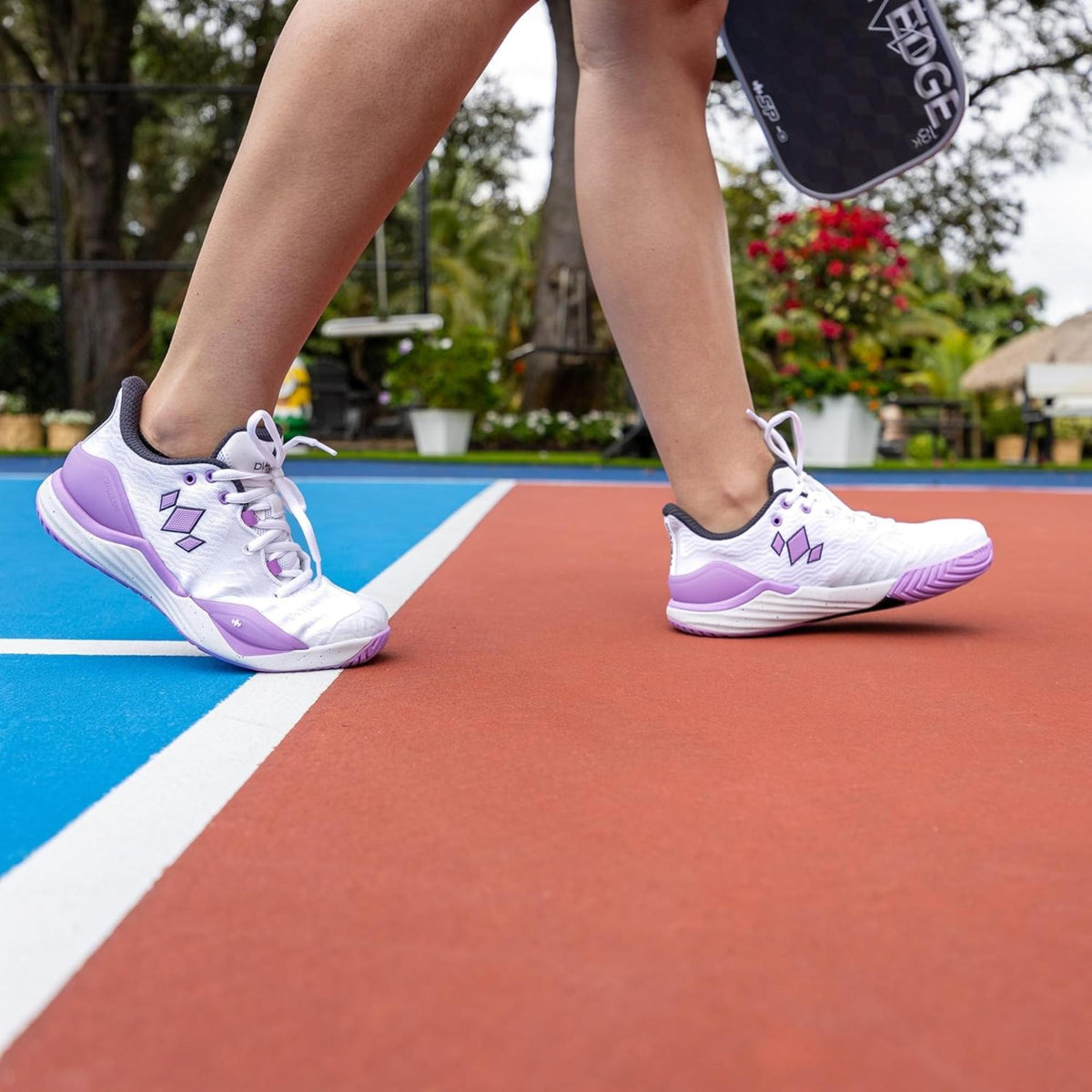 Pair of athletic court shoes with lace-up design, cushioned soles, and supportive structure for court play.