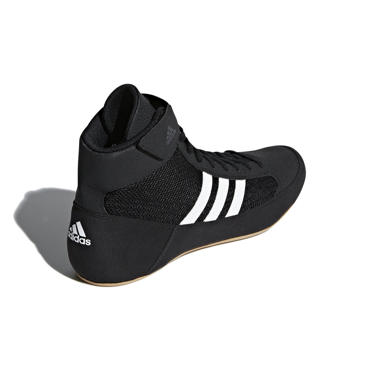 Black high-top wrestling shoe with a breathable mesh upper, black laces, padded ankle strap, and three white diagonal stripes on the side; shown from side and sole views, featuring a tan gum rubber outsole with circular traction patterns and Adidas logo for grip, stability, and mat control.