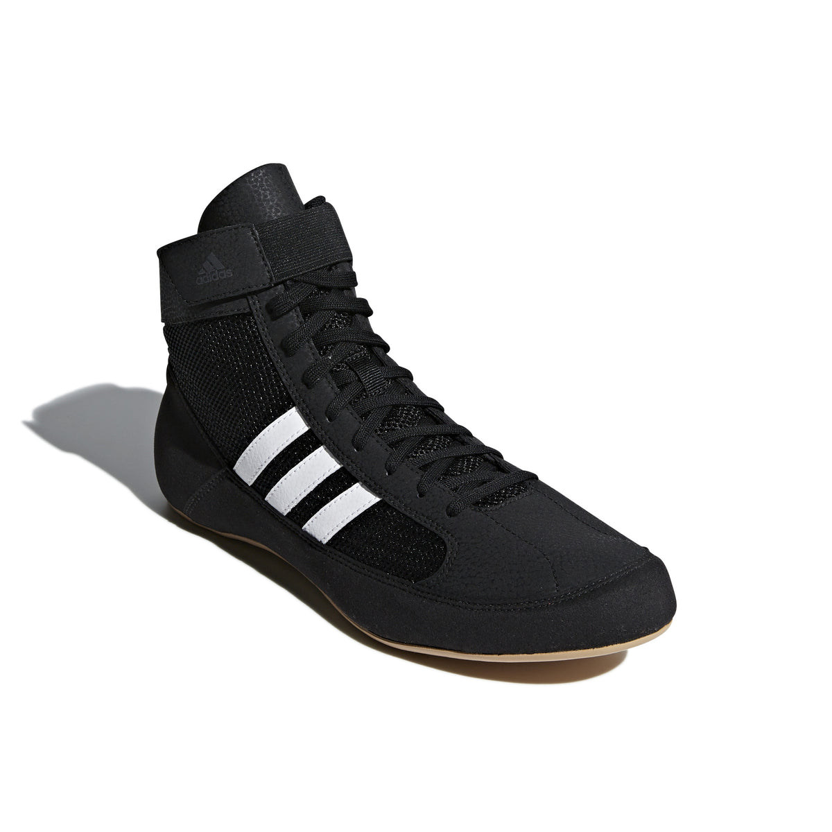 Black high-top wrestling shoe with a breathable mesh upper, black laces, padded ankle strap, and three white diagonal stripes on the side; shown from side and sole views, featuring a tan gum rubber outsole with circular traction patterns and Adidas logo for grip, stability, and mat control.
