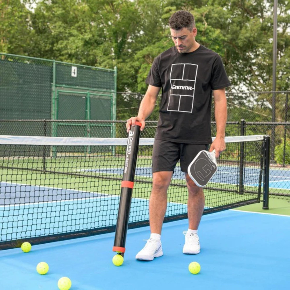 Portable pickleball ball tube with secure lid and shoulder strap, designed for easy storage and transport of pickleballs.