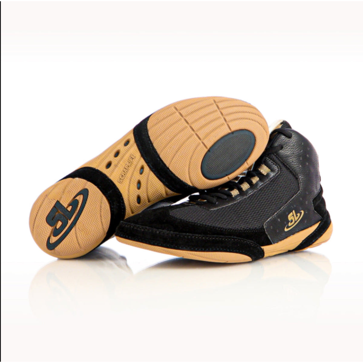 A pair of black and gold Ascend One wrestling shoes with leather armor-zones and a lace-up closure.