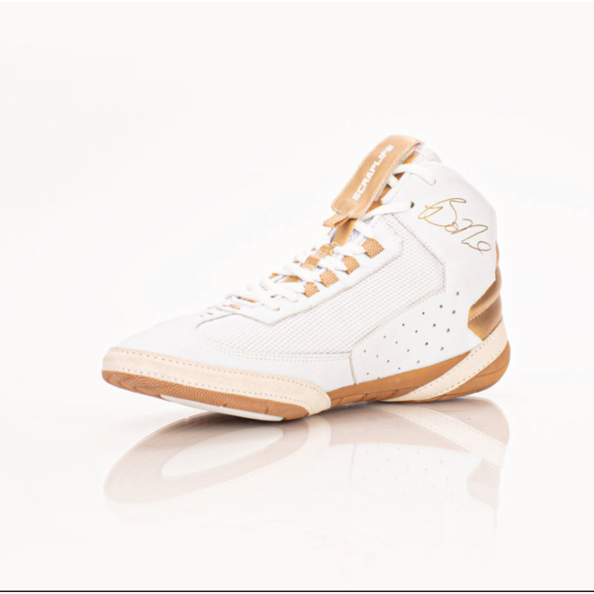 White and tan sneaker on a reflective surface with a white background