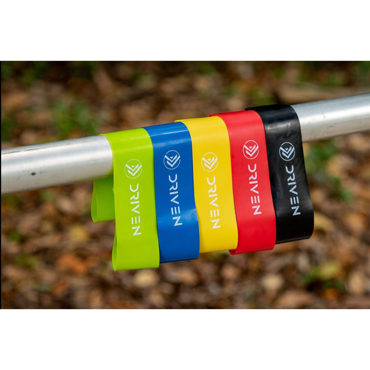 Colorful resistance bands with 'NEARC' branding on a metal bar against a natural background.
