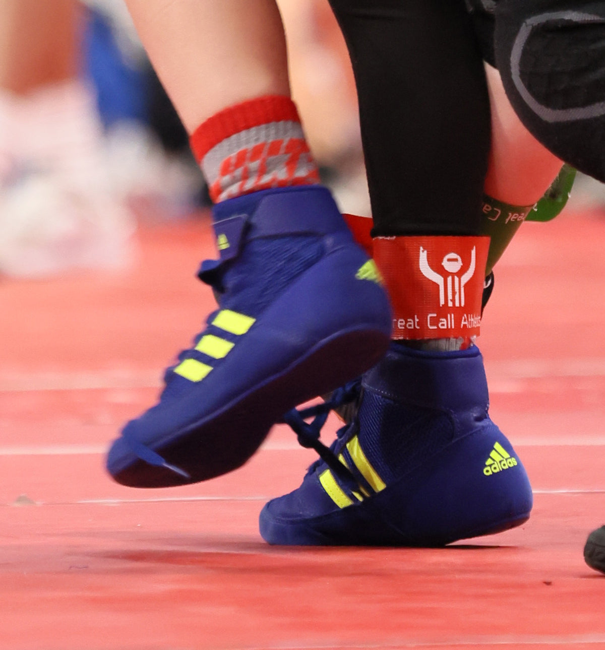 Great Call Athletics red and green wrestling ankle bands in use
