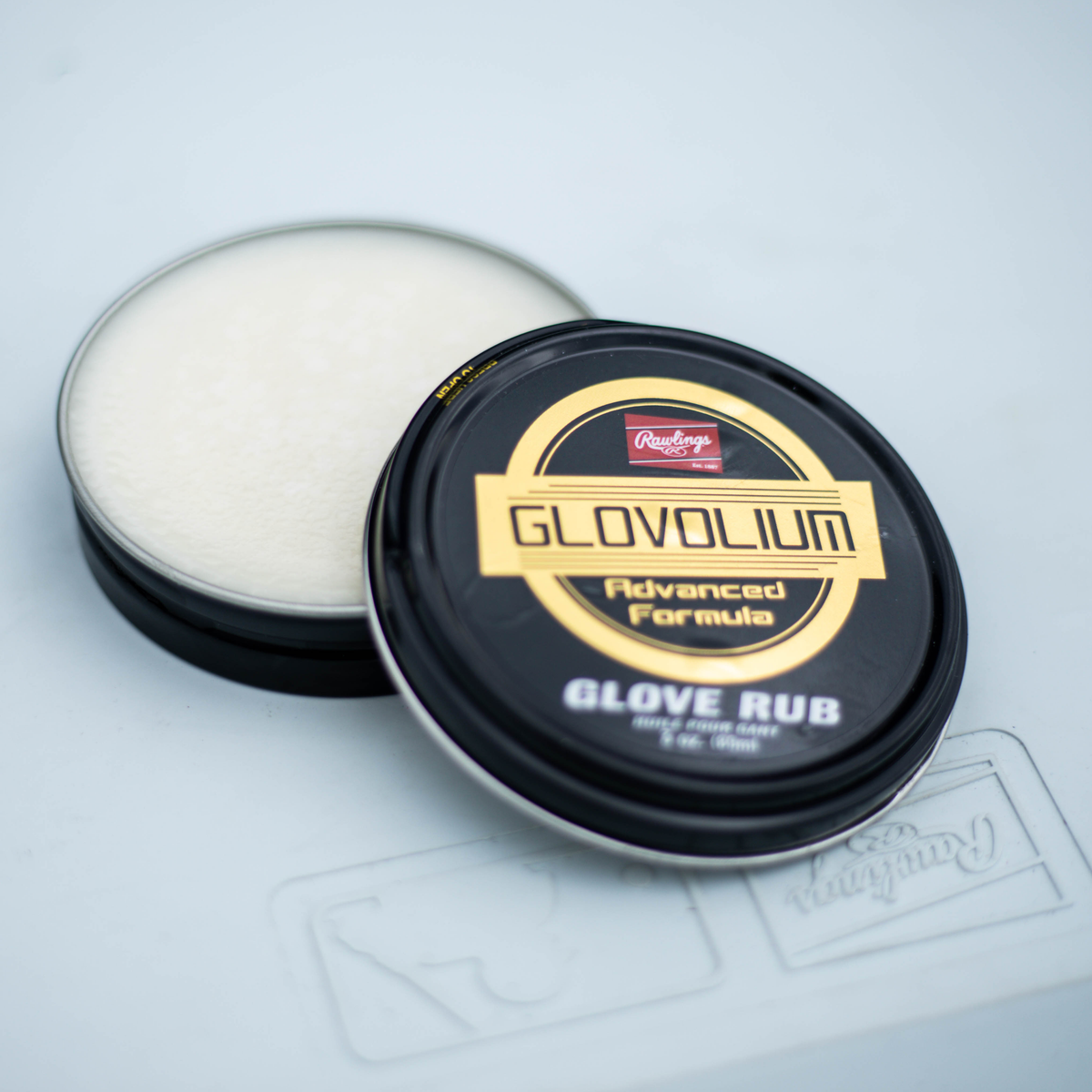 Rawlings Glovolium Advanced Formula glove rub in a small tin, designed to clean, condition, and protect baseball and softball leather gloves while helping maintain flexibility and durability. ⚾