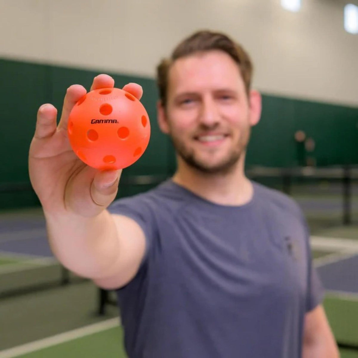 Indoor pickleball with precision-drilled holes, designed for consistent bounce and controlled play on indoor courts.