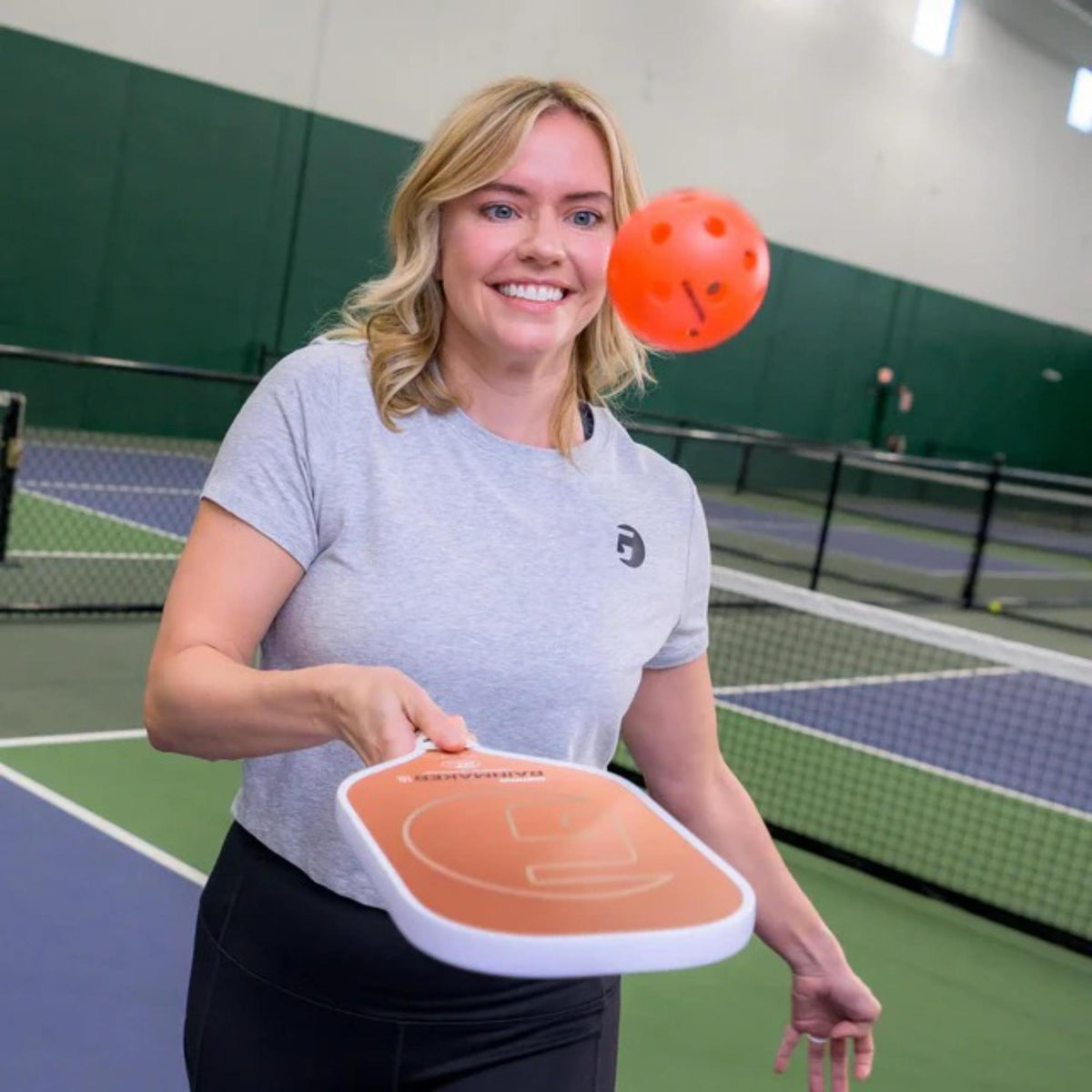 Indoor pickleball with precision-drilled holes, designed for consistent bounce and controlled play on indoor courts.