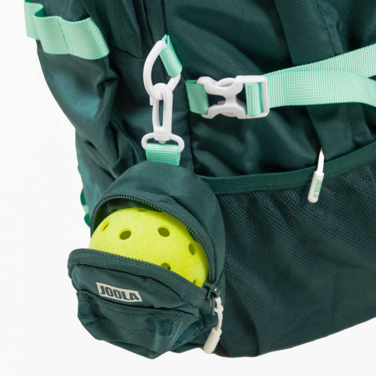 Green backpack with a yellow pickleball ball in a pocket, featuring the Joola brand.