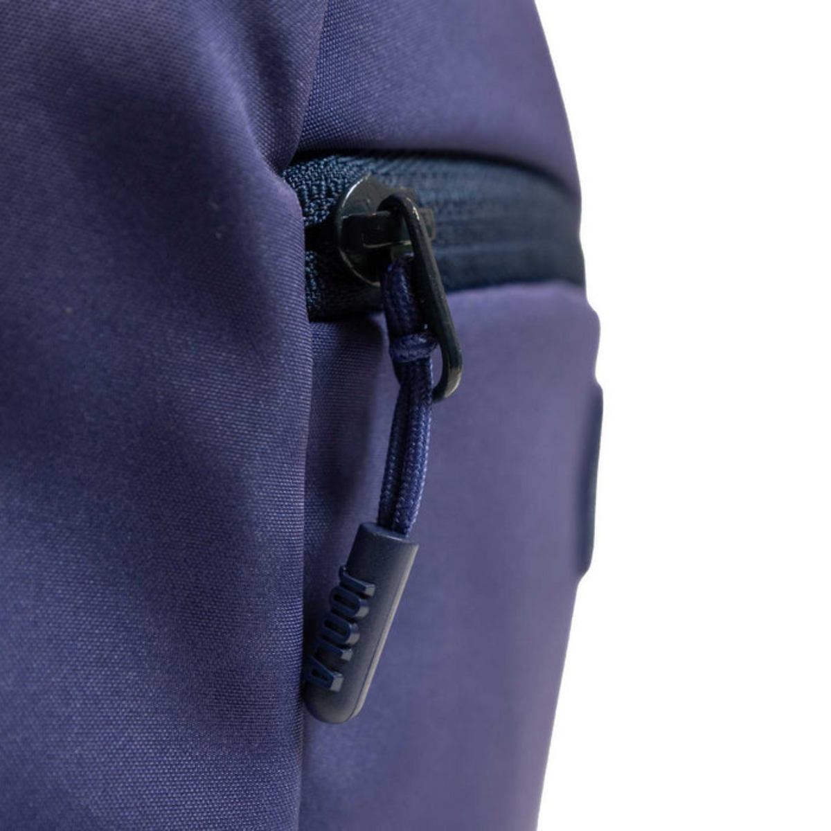 Close-up of a blue zipper on a purple garment with a white background
