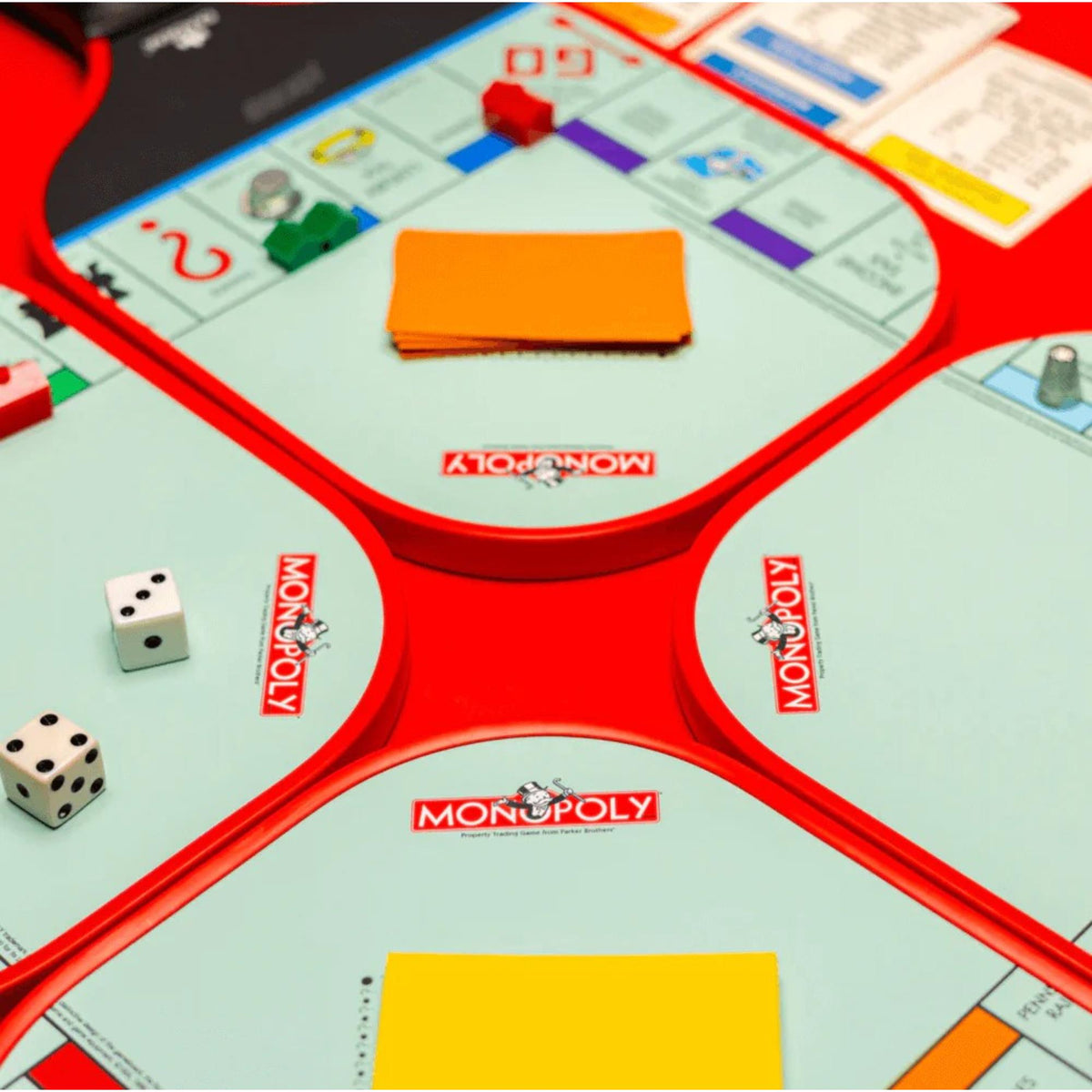 Diadem Monopoly Board 4-paddle starter kit featuring four pickleball paddles with Monopoly board-style graphics, arranged side by side with handles visible.