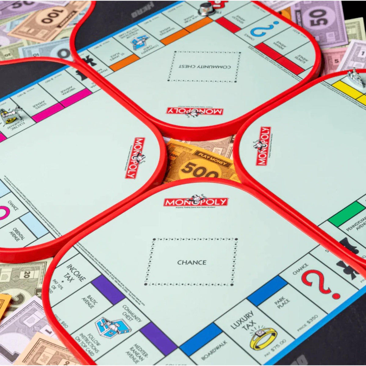 Diadem Monopoly Board 4-paddle starter kit featuring four pickleball paddles with Monopoly board-style graphics, arranged side by side with handles visible.
