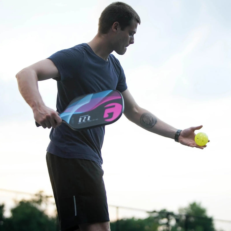 Pickleball paddle with a textured face and ergonomic handle, designed for enhanced control, spin, and performance on the court.