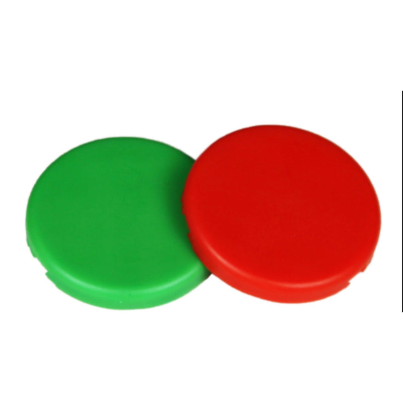 Two round plastic caps, one green and one red, on a white background.