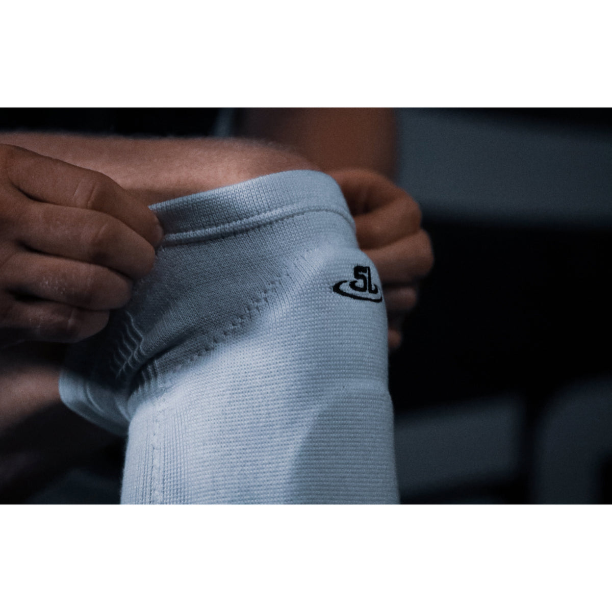 White ankle support brace with a brand logo on a blurred background