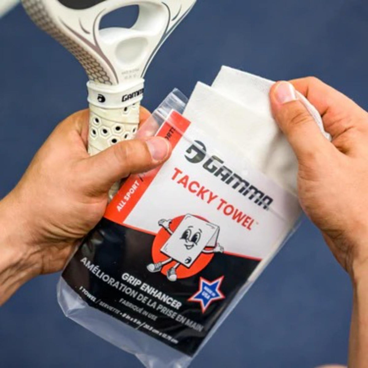 Grip-enhancing tacky towel in retail packaging, designed to improve hand grip and control during sports activities.