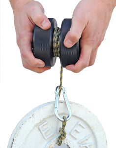 A person's wrist is shown performing a twisting motion with a roller and attached cord, likely made of rubber and metal, used for strength training.