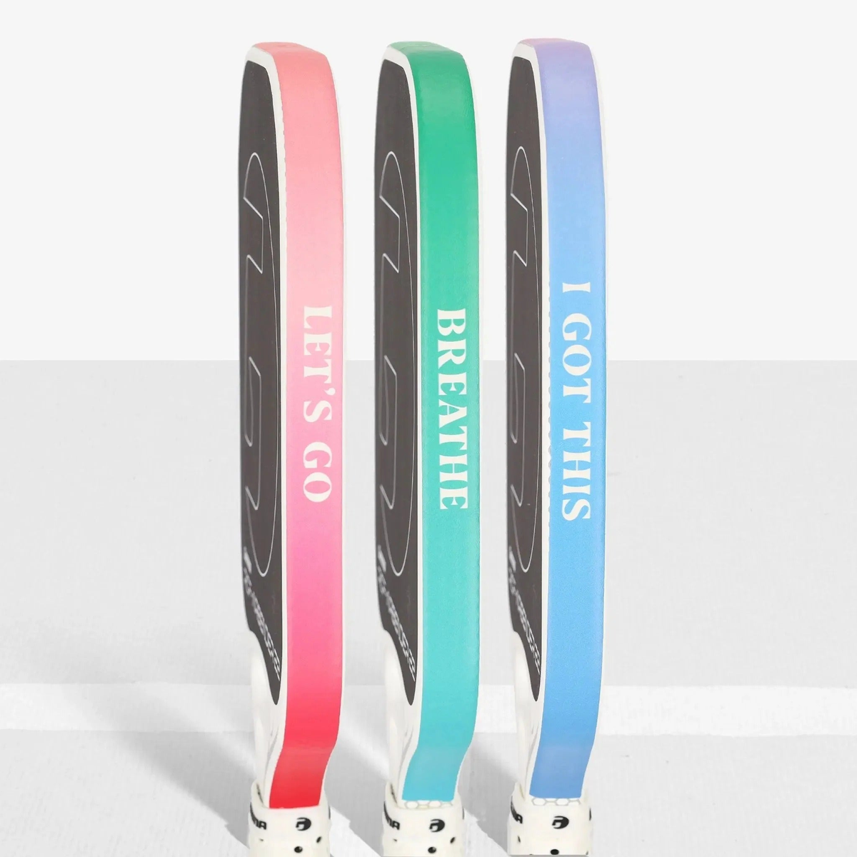 Pickleball paddle edge guard tape with gradient color designs and printed motivational text, designed to protect paddle edges from wear.