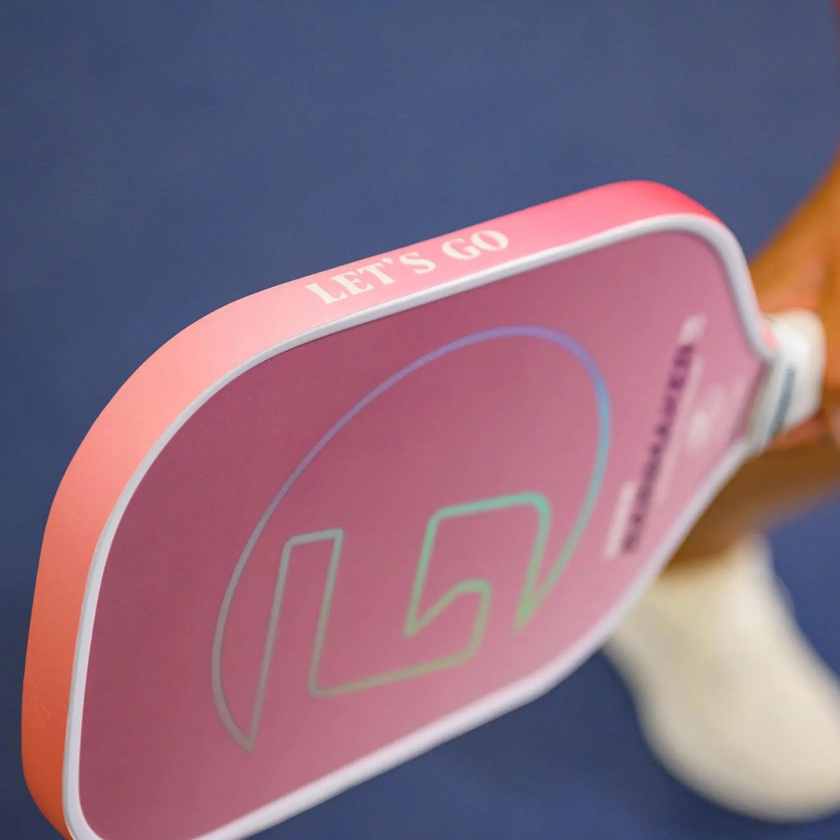 Pickleball paddle edge guard tape with gradient color designs and printed motivational text, designed to protect paddle edges from wear.