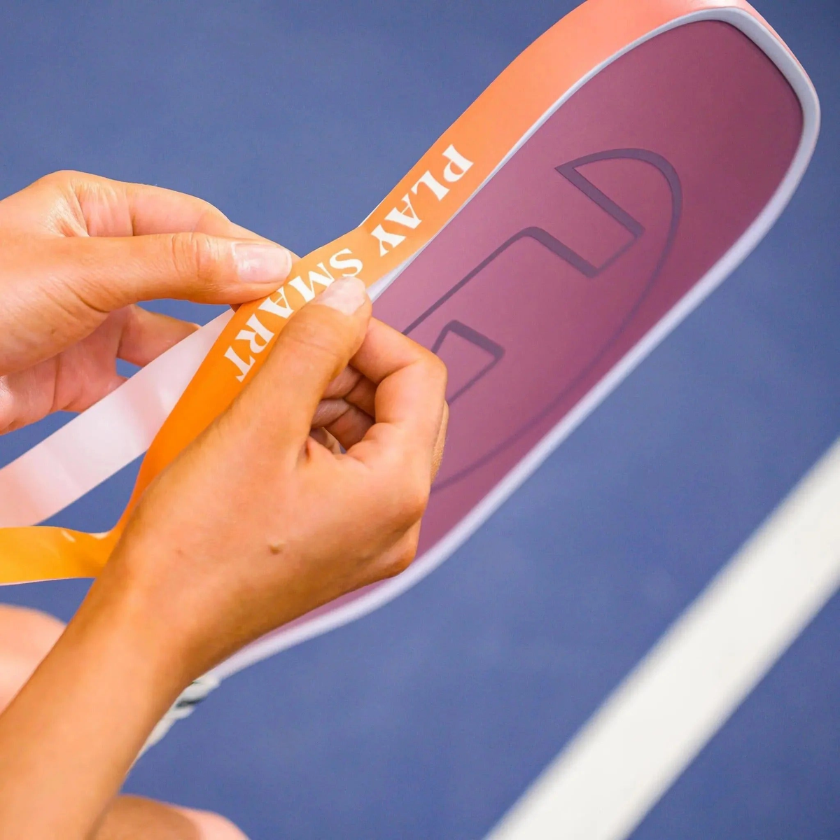 Pickleball paddle edge guard tape with gradient color designs and printed motivational text, designed to protect paddle edges from wear.