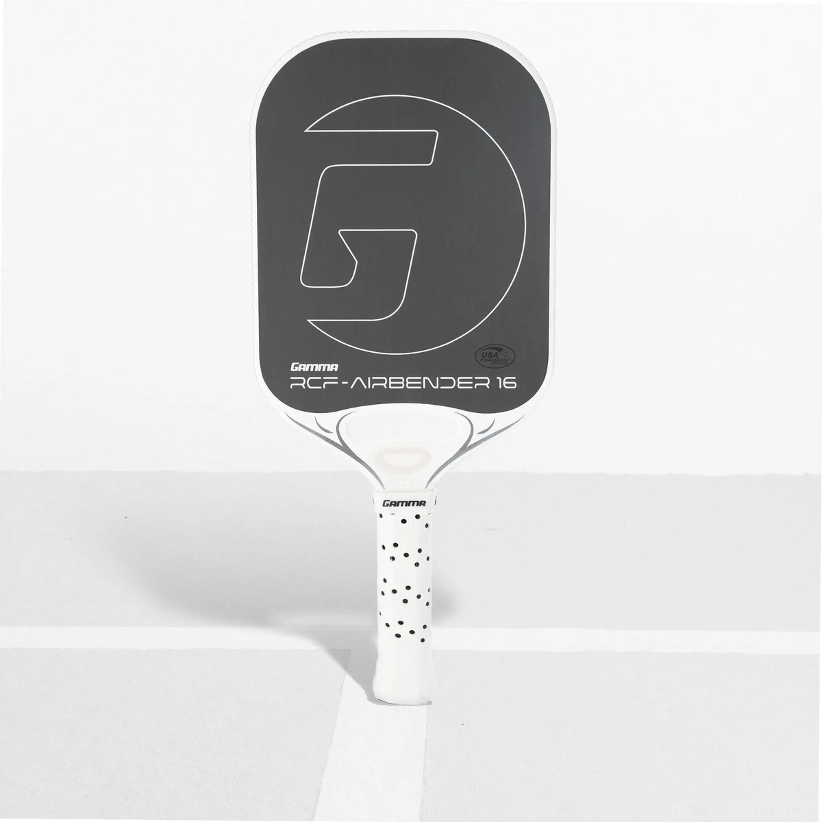 Pickleball paddle with an elongated face design, textured hitting surface, and cushioned perforated grip handle for enhanced control and comfort.