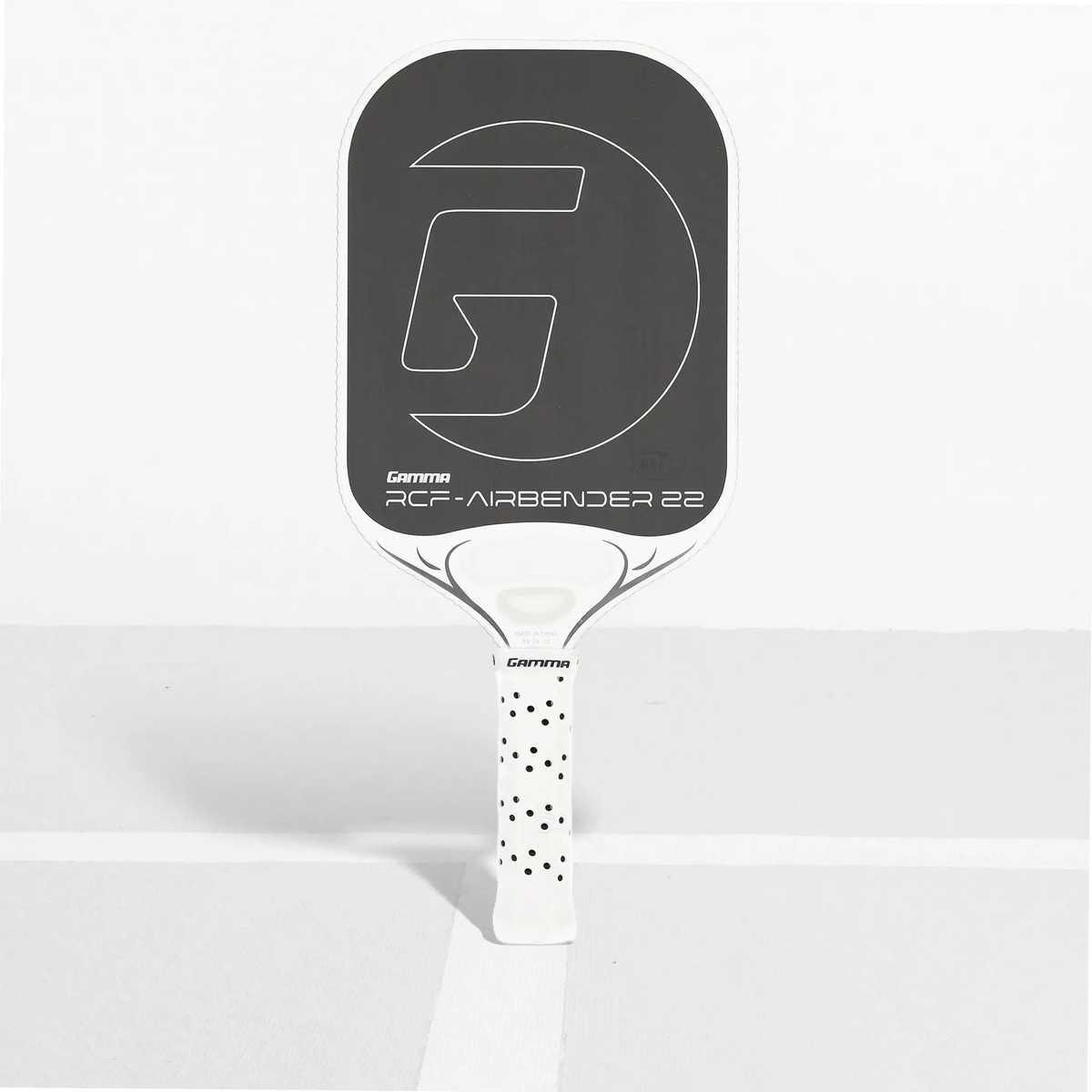 Pickleball paddle with an elongated face design, textured hitting surface, and cushioned perforated grip handle for improved control and comfort.