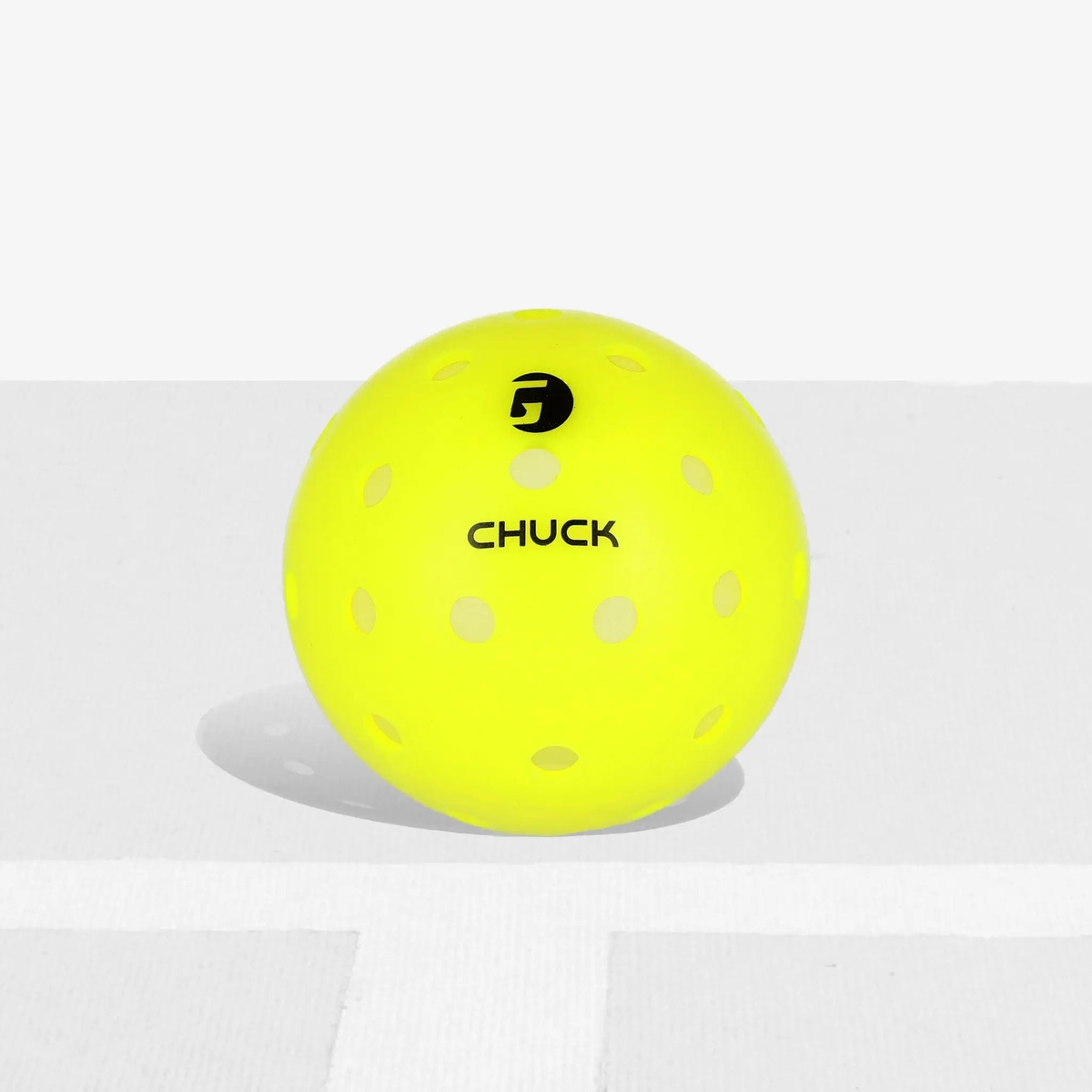 Outdoor pickleball with durable construction and evenly spaced holes, designed for consistent flight and performance during play.