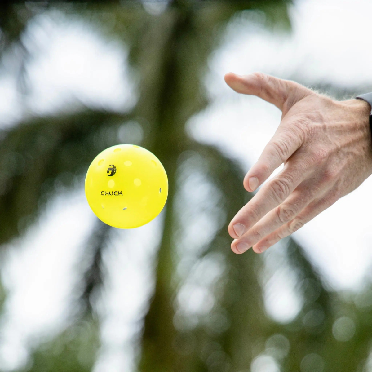 Outdoor pickleball with durable construction and evenly spaced holes, designed for consistent flight and performance during play.