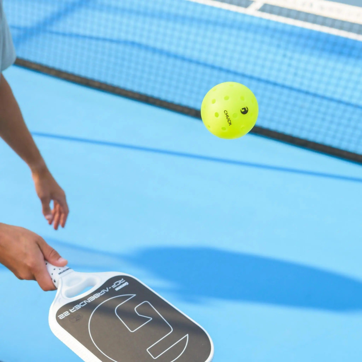 Outdoor pickleball with durable construction and evenly spaced holes, designed for consistent flight and performance during play.