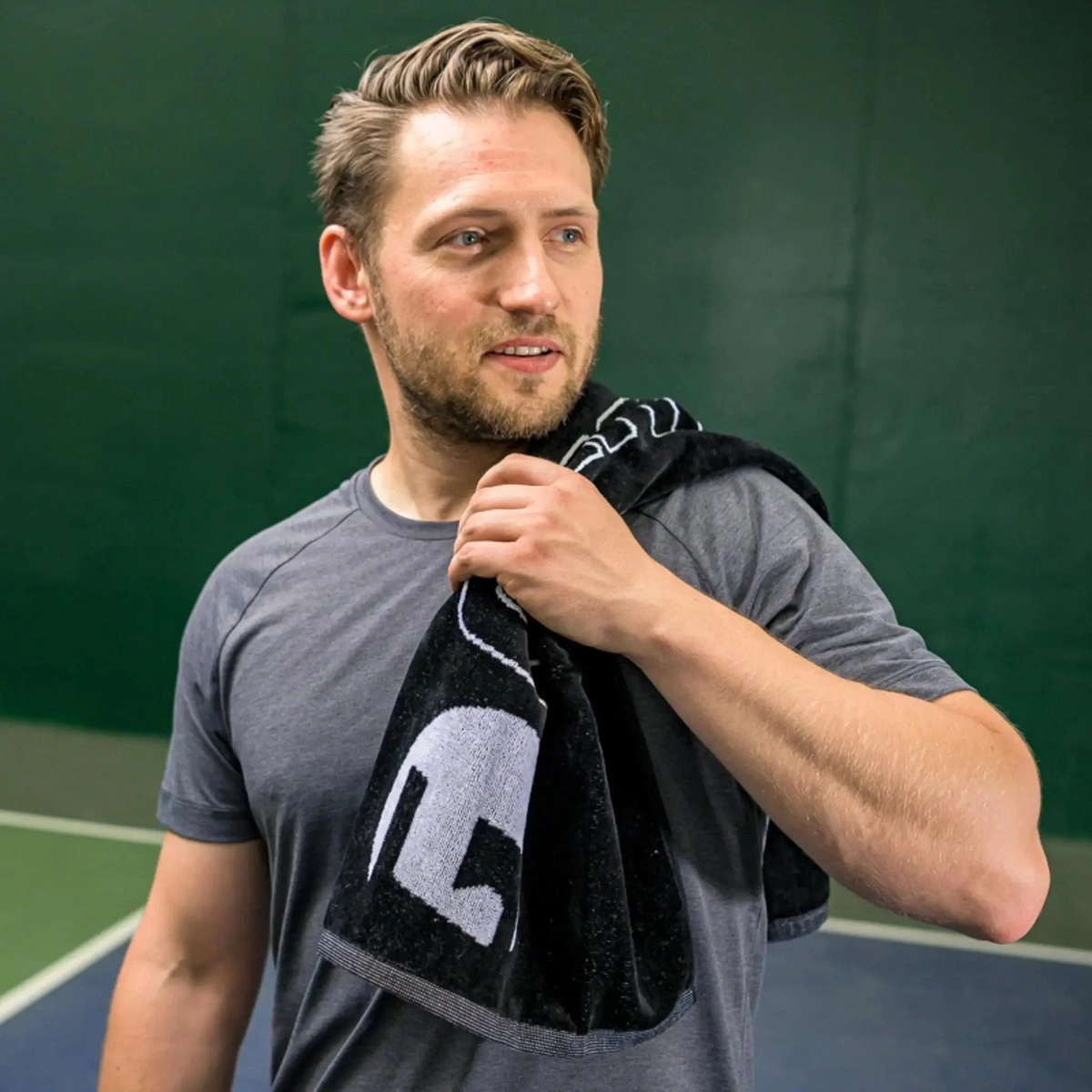 Court towel made from absorbent fabric, designed for wiping sweat and keeping hands dry during play.