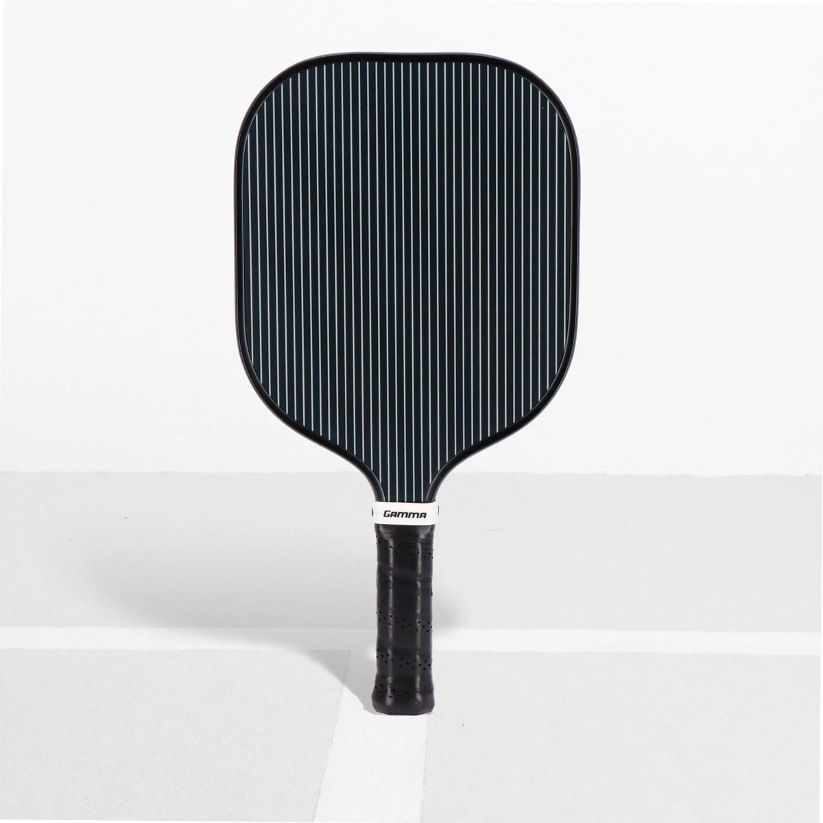 Pickleball paddle with a wide face, striped surface design, and cushioned grip handle for improved control and comfort.