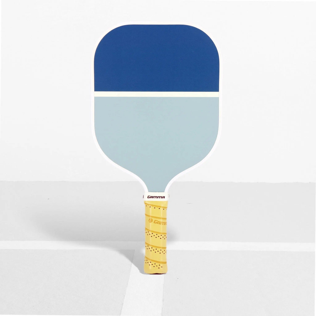 Pickleball paddle with a wide face, striped surface design, and cushioned grip handle for improved control and comfort.