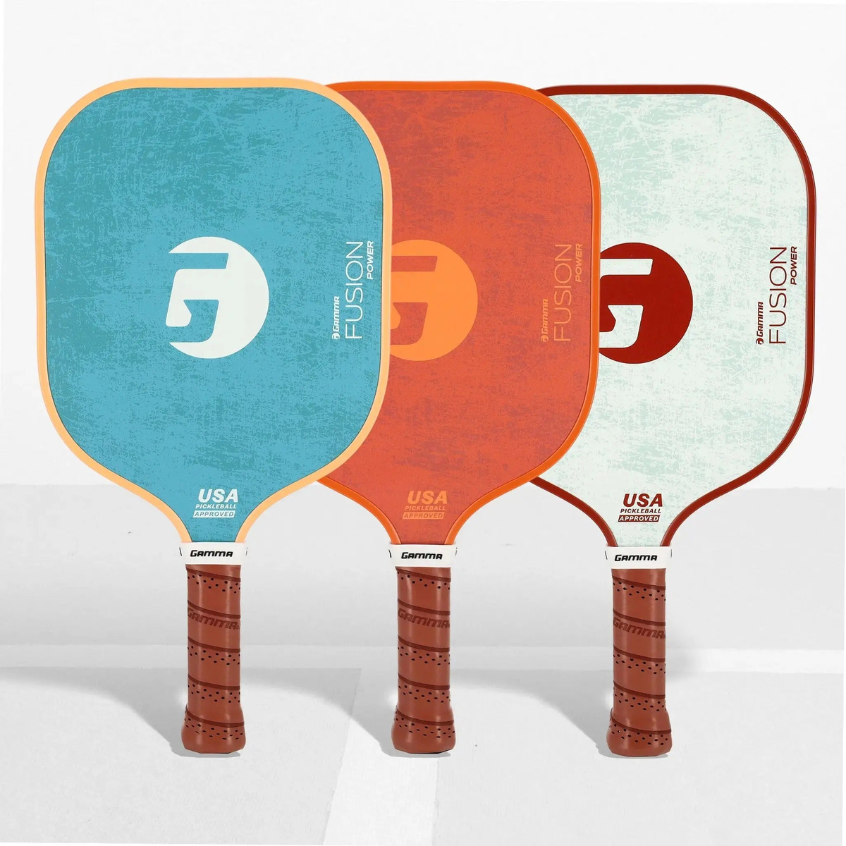 Set of pickleball paddles with wide faces, textured surfaces, and cushioned grip handles designed for power and control.